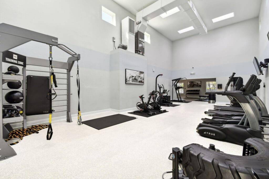 Apartments For Rent In East Orlando, FL - Pine Harbour - Fitness Center With Cardio Equipment, Trx Equipment, Free Weights, And High Ceilings With Sky Lights.